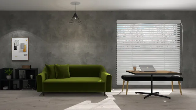 グレーの壁紙で落ち着いた雰囲気の部屋にグリーンのソファが置いてある。
